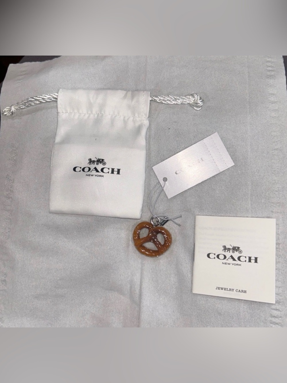 Coach Pretzel Charm with care booklet, tag and Dust Bag. NWT